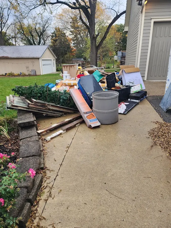 Dumpster being loaded with debris for Estate Cleanout Dumpster Rental in Texarkana